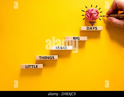 Little things make big days symbol. Wooden blocks with words Little things make big days. Beautiful yellow background, copy space. Businessman hand, l Stock Photo