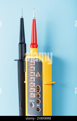 Two-pole voltage indicator close-up on a blue background. Testing and verification of electrical networks Stock Photo