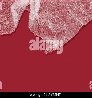 Bubble wrap with shadow against red background Stock Photo
