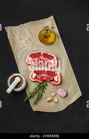 Overhead view of raw fresh lamb double loin chop on wrapping paper Stock Photo