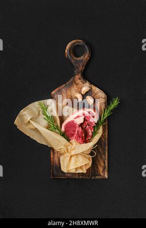 Raw fresh lamb double loin chop wrapped in paper Stock Photo