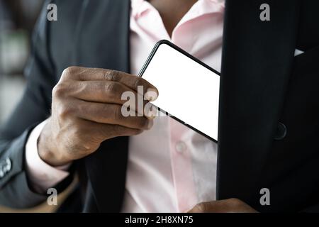 African Man Holding Cellphone Or Mobile Phone Stock Photo