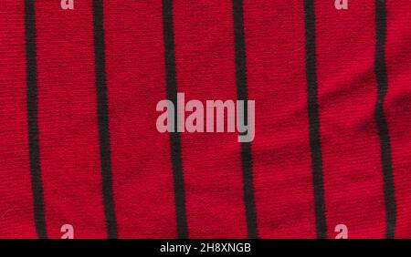 Magneta knitted background with copy space.  Beautiful knitted purple burgundy colored wool textiles with black stripes Stock Photo