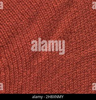 Knitting purple texture of sweater close up. Knitted textured red fabric background. Stock Photo