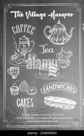 Signboard standing in the village of Sonning-on-Thames, Berkshire advertising local teashop called The Village Hamper in the centre of the village Stock Photo