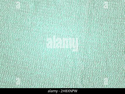 Warm mint blue woolen braids are knitted with threads background. Acrylic or cotton mint handmade knit fabric canvas texture. Stock Photo