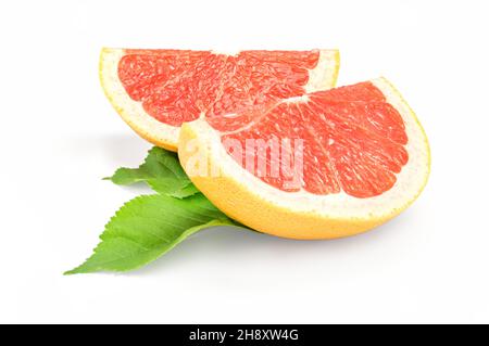 Two slices of grapefruit on white background with green leaves Stock Photo