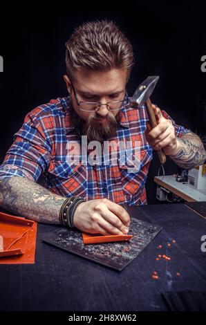 Craftsman working with leather working as artisan Stock Photo