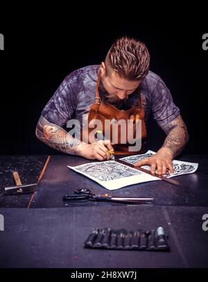 Leather Artisan forms new leather product at the work area Stock Photo