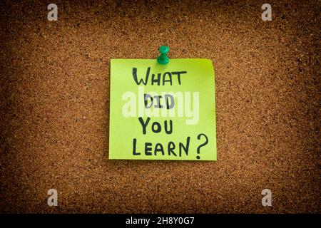 A sticky note with the question what did you learn written on it. Close up. Stock Photo