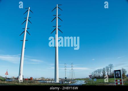 Row of new electricity pylons under construction in the province of Groningen, the Netherlands Stock Photo