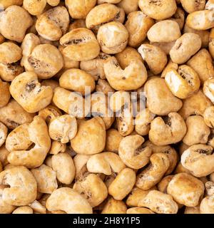 Top view, closeup of canjica, hominy or white corn popcorn, sweet popcorn. Stock Photo