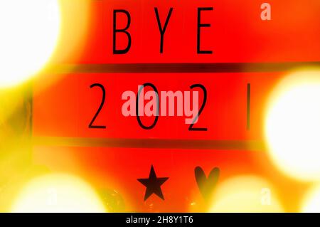 Letter board light box with text BYE 2021, new year 2022 concept, light bokeh. Stock Photo