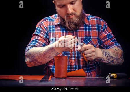 Leather master producing leather goods Stock Photo