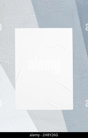 gray painted urban wall with wrinkled glued poster template Stock Photo