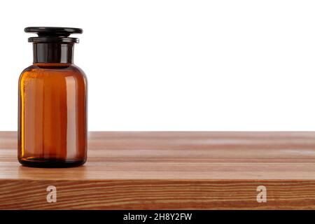 Brown medical bottle on table on front background view. Concept of herbal medicine. Stock Photo