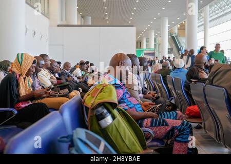 Addis Ababa, Ethiopia - April 23, 2019: Local passengers checking their phones and tablets while waiting in departure hall of Bole International Airpo Stock Photo