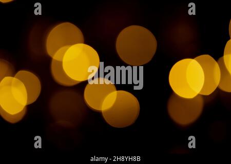 Abstract yellow bokeh texture on black background. Stock Photo