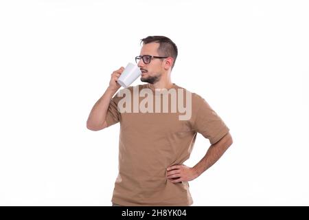 Man Drinking Coffee from Cup. Man With Cup in Hands. Stock Photo