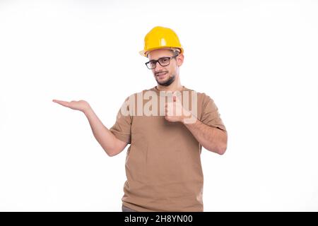 Builder Holding Hand to Side Showing Thumb Up Isolated. Man Construction Worker Sign. Advertisment, Commercial, Business concept Stock Photo