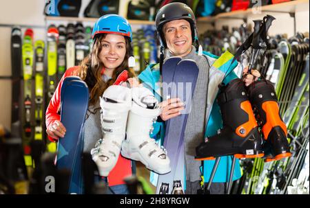 man and woman in helmets choosing sports equipment Stock Photo - Alamy