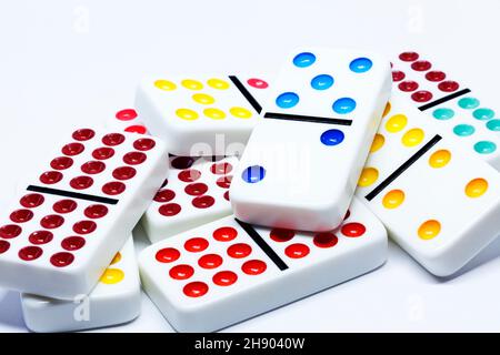 colorful dominoes lying in a pile on white background Stock Photo