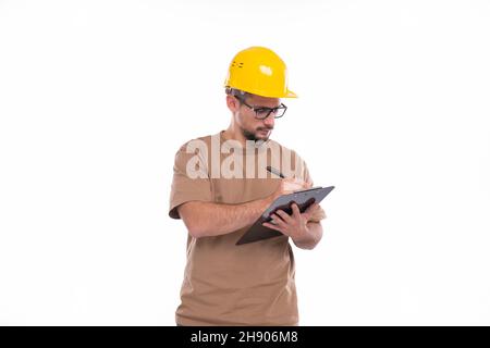 Man Construction Worker Writing in Clipboard Isolated. Man Builder Working with Clipboard. Commecial, Shopping, Advertisment Concept Stock Photo