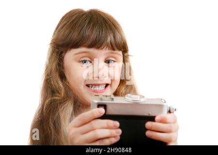 Cheerful Little Girl make a Selfie with Retro Photo Camera on the White Background Stock Photo