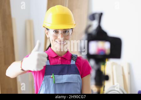 Happy woman construction site worker show thumbs up on camera Stock Photo