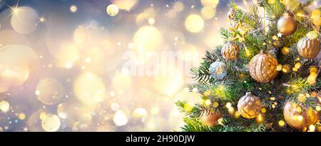 Christmas Tree In Golden Sparkle Background - Shiny Balls With Vintage Defocused Abstract Lights Stock Photo