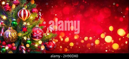 Christmas Tree In Red Background - Ornament And Abstract Defocused Lights Stock Photo