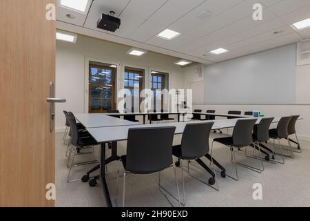 flexible classroom at a university. Due to desk chairs and wheels under the table, students can easily change the set up of a room during a meeting Stock Photo