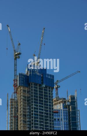 large tower cranes on a construction site in central london builing a new skyscraper or multi-storey block of flats or offices. tower cranes building. Stock Photo