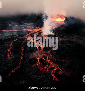 Aerial shot of the Fagradalsfjall eruption in Iceland with smoke and lava flow. Stock Photo