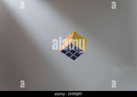 colorful cube flying to light on white background, selective focus, material concept Stock Photo