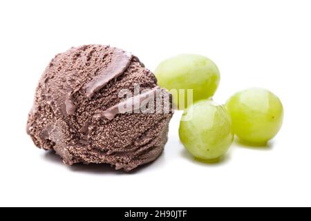 a single chocolate ice cream scoop and a few green grapes on white background Stock Photo