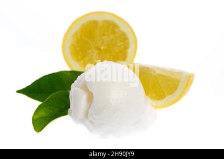 single lemon ice cream scoop with lemon slice and lemon leafs isolated on white background Stock Photo