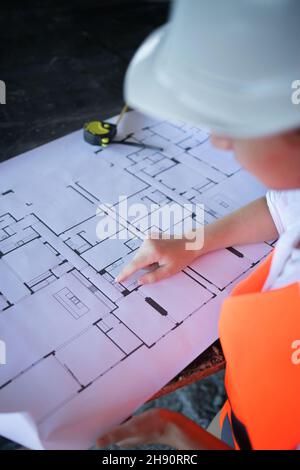 Architect working over plan. Closeup Desk With blueprints drawing Stock Photo