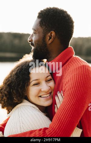 Smiling woman embracing boyfriend during weekend Stock Photo