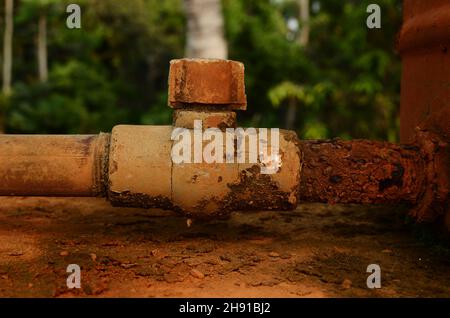Another pipe is added to the corroded water pipe Stock Photo