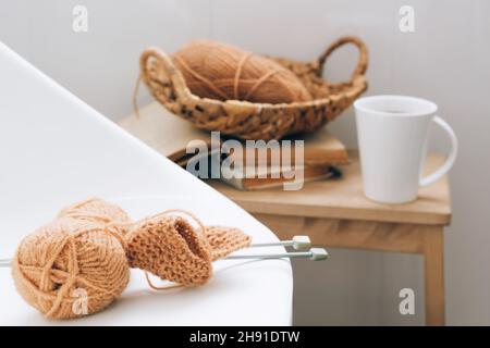 Threads for knitting, from natural environmentally friendly wool, close-up on a light background. Hobby home needlework Stock Photo