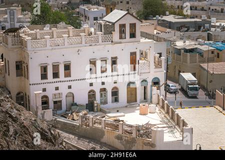 Muscat, Oman - 04.04.2018: Traditional old house in arabian style in the old city of Muscat on a hot day. Terrace on the roof. Stock Photo