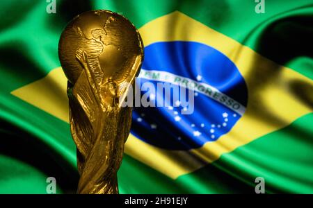 October 6, 2021 Brasilia, Brazil. FIFA World Cup on the background of the flag of Brazil. Stock Photo