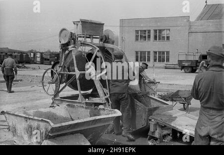 Warszawa, 1947-04-26. Odbudowa ze zniszczeñ wojennych lotniska cywilnego na Okêciu. Nz. robotnicy przy betoniarce. wb  PAP      Warsaw, April 26, 1947. Rebuilding the Okecie civilian airport from war damage. Pictured: workers at a concrete mixer.  wb  PAP Stock Photo