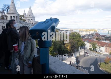 Budapest, Hungary - 1 November 2021: Observation deck with binoculars. Tourist people at landmark, Illustrative Editorial. Stock Photo