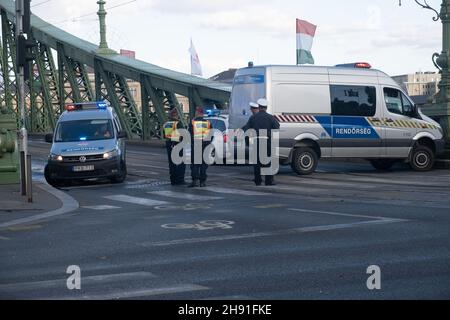 Budapest, Hungary - 1 November 2021: Hungarian police officers blocked the bridge in cars and a van. Rendorseg at work, Illustrative Editorial. Stock Photo