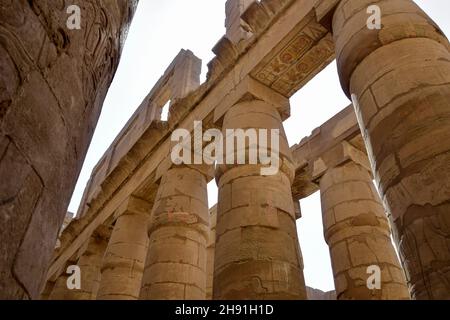 Ancient Egyptian hieroglyphs and symbols carved on columns of the complex of the Karnak temple. Great Hypostyle Hall at the Temples of Karnak (ancient Stock Photo
