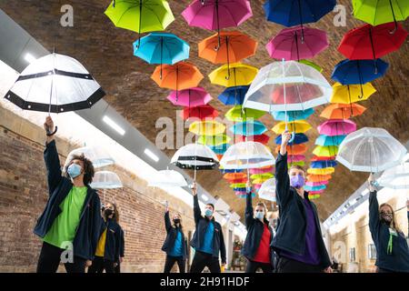 Dancers perform with umbrellas during a flash mob at London Bridge Station to mark International Day of Persons with Disabilities and help raise awareness of their situation in every aspect of life. Picture date: Friday December 3, 2021. Stock Photo