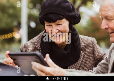 Happy senior couple using digital tablet during weekend Stock Photo