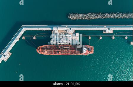 Aerial top down view of an oil tanker ship in process of loading Stock Photo